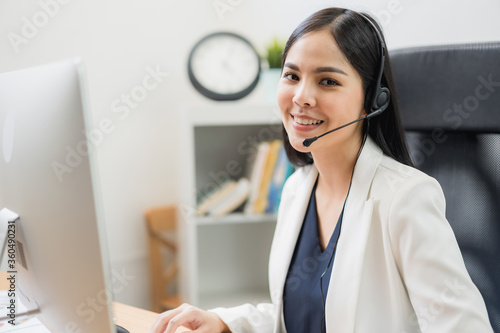 Young business asian woman working call centre customer service agents. Business female support operator with computer and headset in office.
