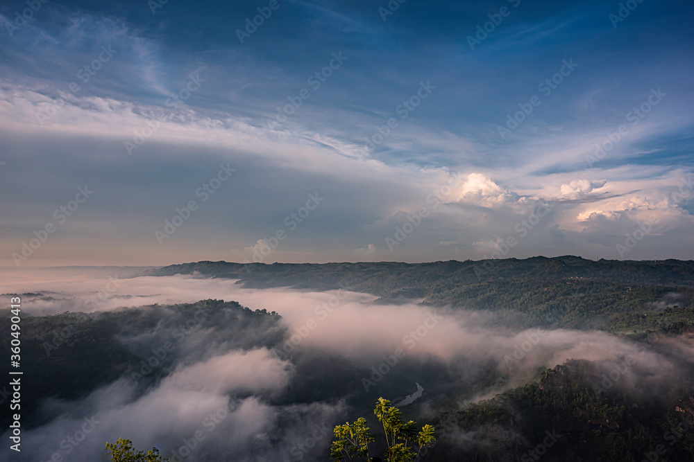 Cloudy blue sky background in foggy misty valley in Java Island, Indonesia