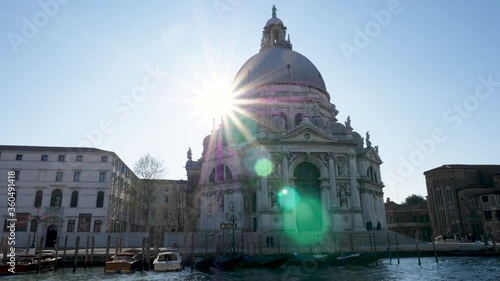 Slow motion boat ride view of landmark church in Venice, Italy with lens flare