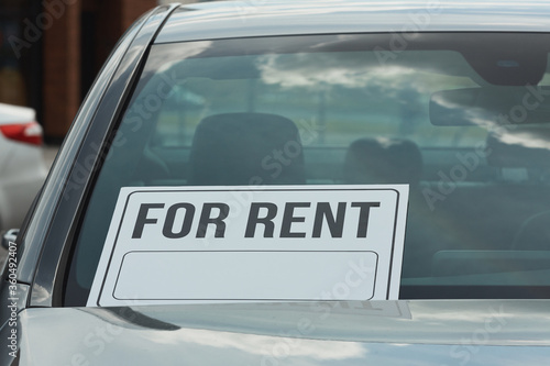 Close-up of car with placard on it is for rent