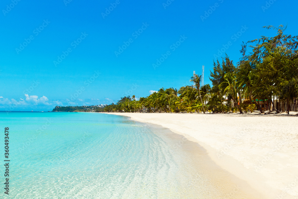 Beautiful landscape of tropical beach on Boracay island, Philippines. Coconut palm trees, sea, sailboat and white sand. Nature view. Summer vacation concept.