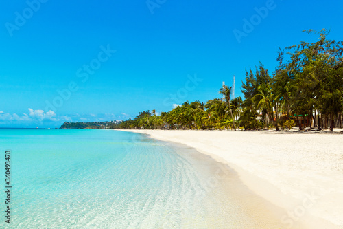 Beautiful landscape of tropical beach on Boracay island, Philippines. Coconut palm trees, sea, sailboat and white sand. Nature view. Summer vacation concept. © frolova_elena
