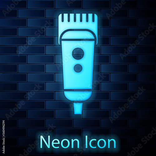 Glowing neon Electrical hair clipper or shaver icon isolated on brick wall background. Barbershop symbol. Vector Illustration.