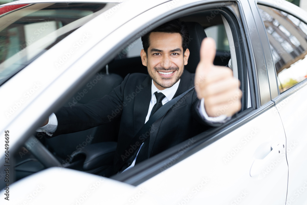 Businessman In Car Showing Thumbs Up