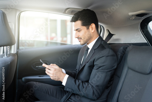 Businessman Using Smartphone In Taxi © AntonioDiaz