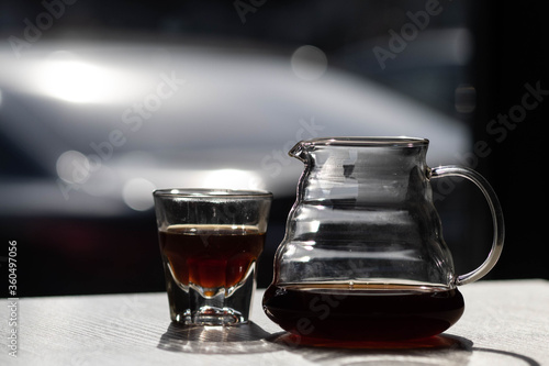 brewing coffee in a funnel. glass teapot with specialty of freshly brewed coffee. on a beautiful table, the kettle is steaming. brewing coffee. Pour Over Coffee In Funnel. Alternative Method