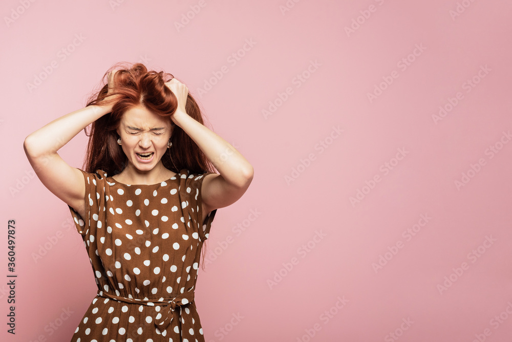 Crying emotional angry woman screaming on pink studio background. Emotional, young face. Female half-length portrait Crying emotional angry woman screaming on pink studio background. Emotional, young face. Female half-length portrait