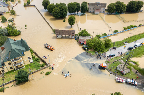 Aerial view of flooded houses and rescue vehicles saving people in Halych town, western Ukraine. photo