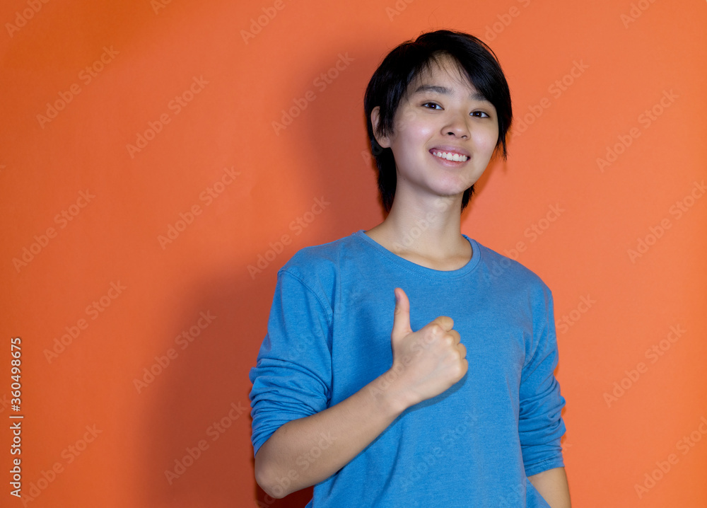 Positive chinese young adult man with blue shirt Positive chinese young adult man with blue shirt
