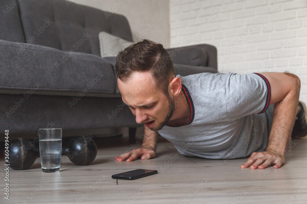 Obraz premium fitness, sport, training and concept - indian man doing push ups at home