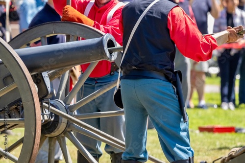 men loading a cannon during an American civil war reenactment 