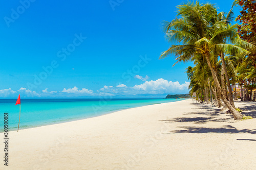 Beautiful landscape of tropical beach on Boracay island  Philippines under lockdoun. Coconut palm trees  sea  sailboat and white sand. Nature view. Summer vacation concept.