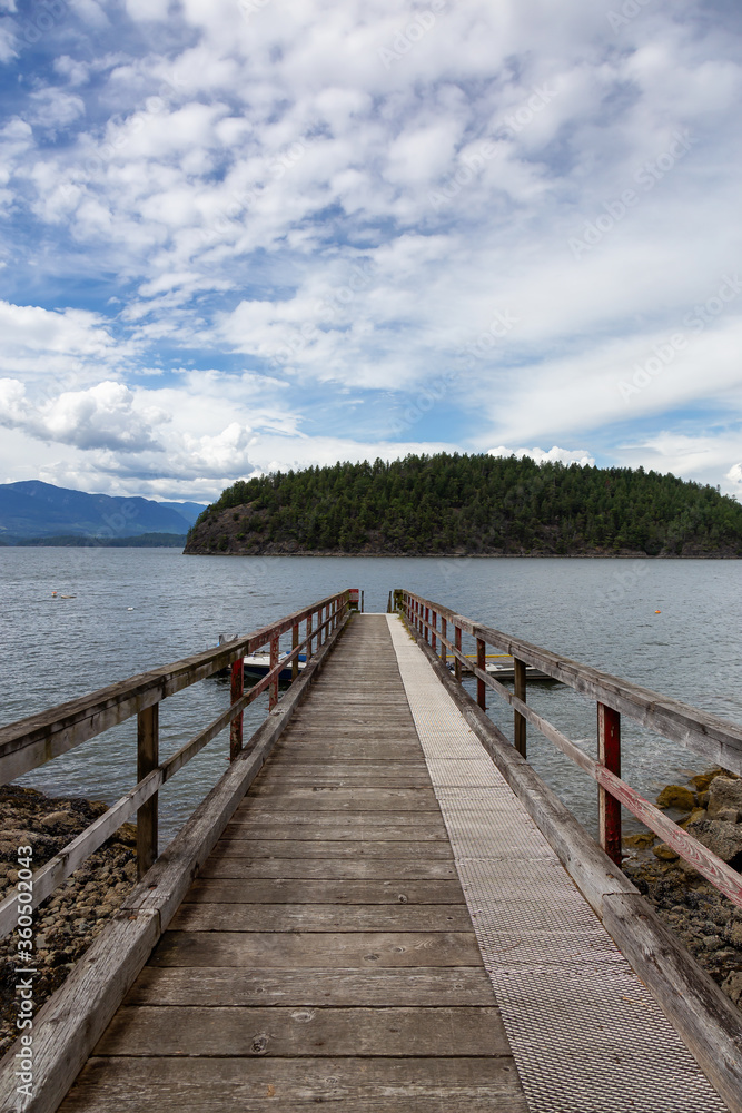 Beautiful View of a wooden Quay with Howe Sound and Hutt Island in Background. Taken in Bowen Island, British Columbia, Canada.