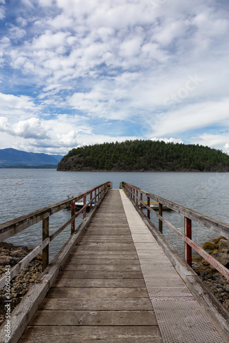 Beautiful View of a wooden Quay with Howe Sound and Hutt Island in Background. Taken in Bowen Island, British Columbia, Canada.