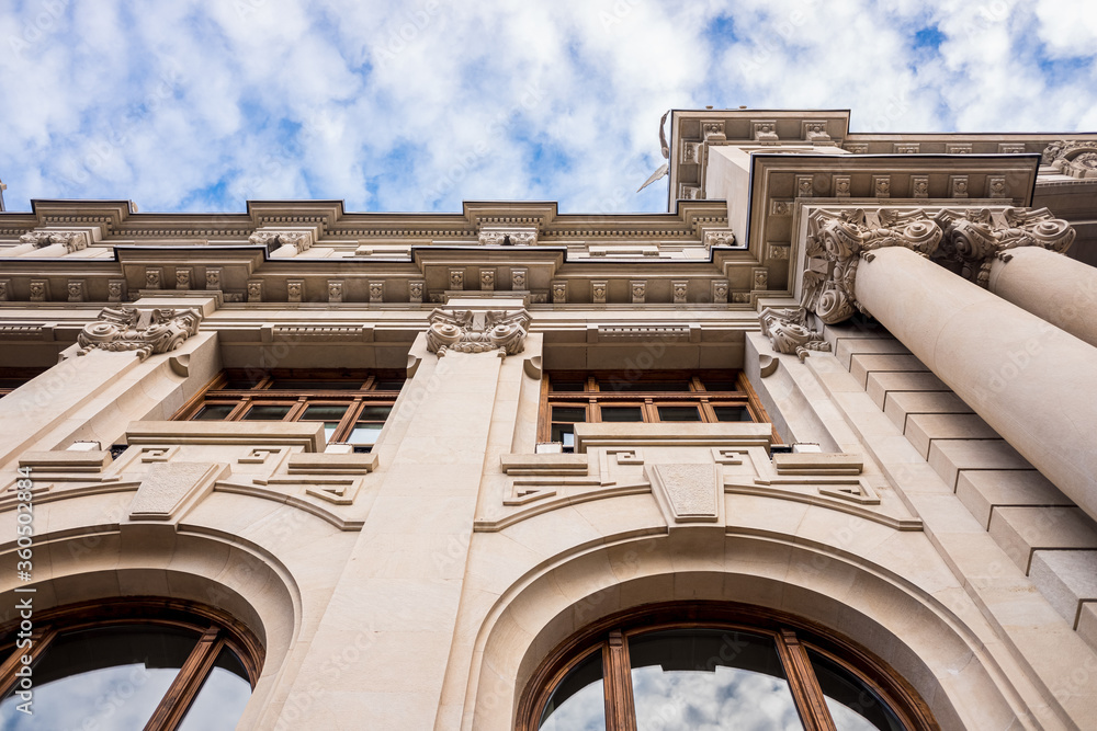 Fototapeta premium Facade of large institutional building with large columns and windows, background sky, low angle shot, in Valencia.