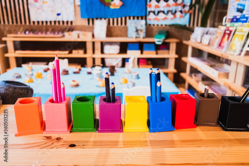 Colored pencils in metal pails in a nursery school