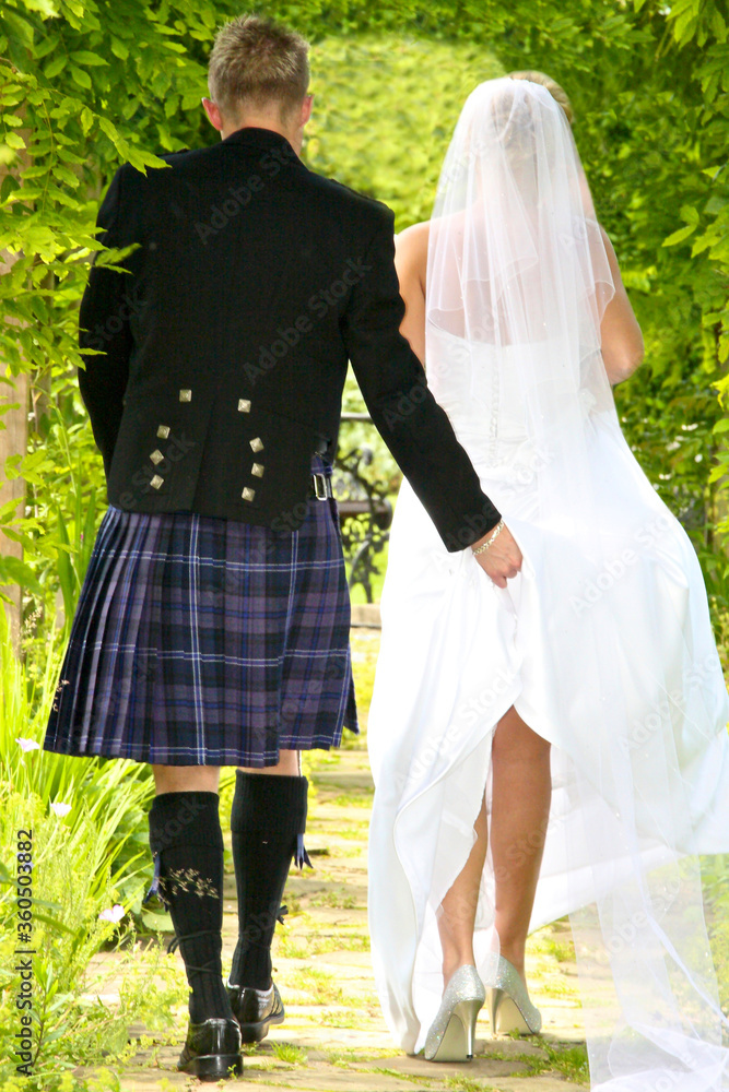 bride and groom walking in the park bride and groom walking in the park