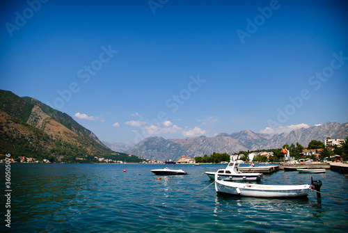Boats at the pier in a Bay surrounded by mountains