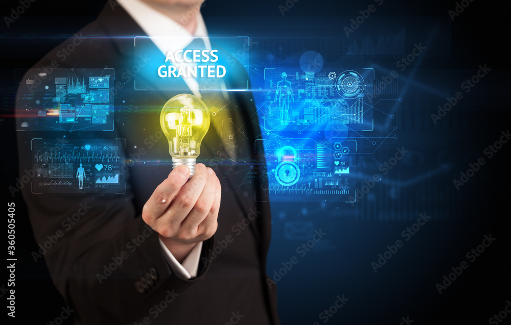 Businessman holding lightbulb with ACCESS GRANTED inscription, online security idea concept Businessman holding lightbulb with ACCESS GRANTED inscription, online security idea concept
