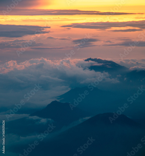 Mountains and clouds at sunset from an airplane