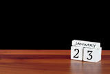 23 January calendar month. 23 days of the month. Reflected calendar on wooden floor with black background