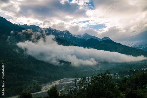 Mountain peaks of the small Himalayan mountains in the clouds