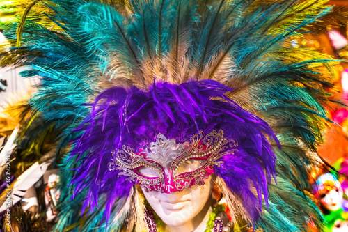 Fototapeta Naklejka Na Ścianę i Meble -  Colorful Red Mask Purple Feathers Mardi Gras New Orleans Louisiana