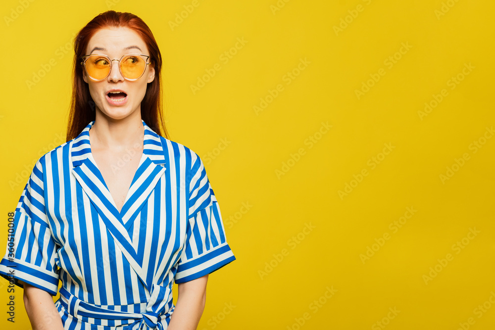 surprised girl is on the yellow background. A girl with beautifull red hair surprised girl is on the yellow background. A girl with beautifull red hair