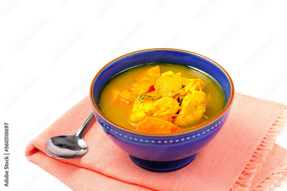 Yellow hot sour fish with yam and light mango served with fried salted fish/ Local food in southern Thailand Yellow hot sour fish with yam and light mango served with fried salted fish/ Local food in southern Thailand