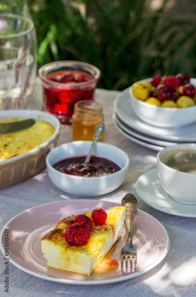 Breakfast in the garden from casseroles, berries, sauces and drinks. Rustic style. Breakfast in the garden from casseroles, berries, sauces and drinks. Rustic style.