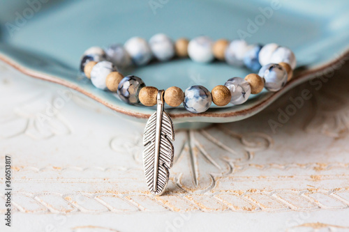 Wooden and agate mineral stone beads bracelet with feather pendant photo