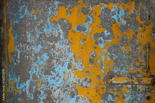 Texture of an old door painted with different colors. Abstract background. © Liliya