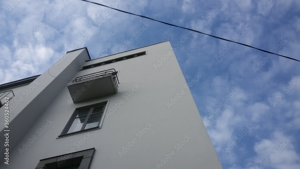 White building corner against the blue sky