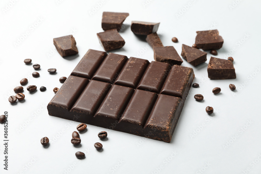 Chocolate bar and coffee seeds on white background Chocolate bar and coffee seeds on white background