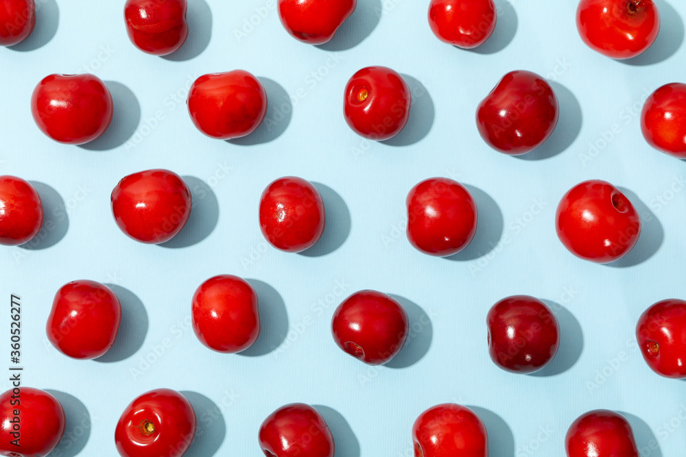 Flat lay with red cherry on blue background, top view Flat lay with red cherry on blue background, top view