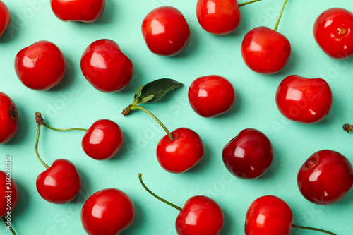 Flat lay with red cherry on mint background  close up