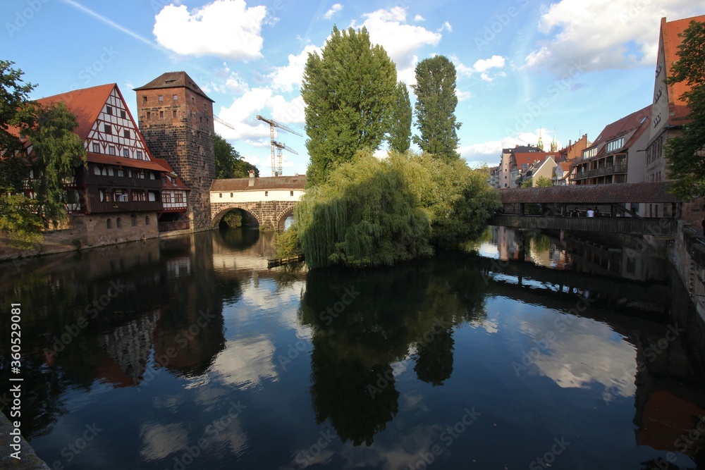 A classic view of Nuremberg, beautiful old bridge with medieval tower and half timbered house A classic view of Nuremberg, beautiful old bridge with medieval tower and half timbered house