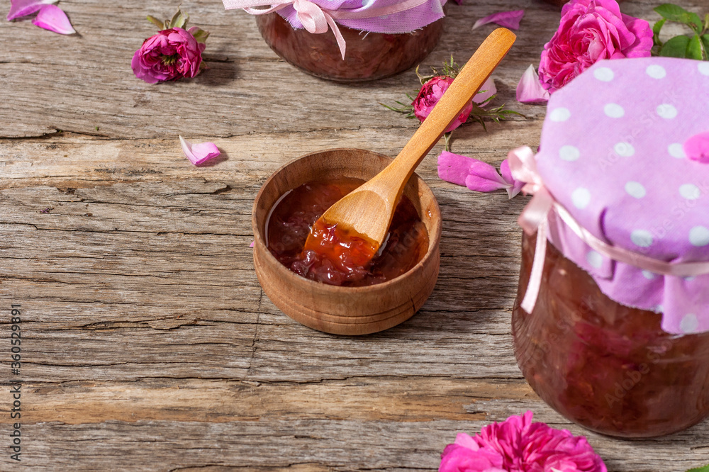 Homemade tea rose petal jam on a old wooden table