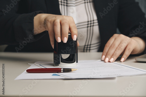 Obraz na płótnie Female notary stamping agreement, company secretary, official document, validity