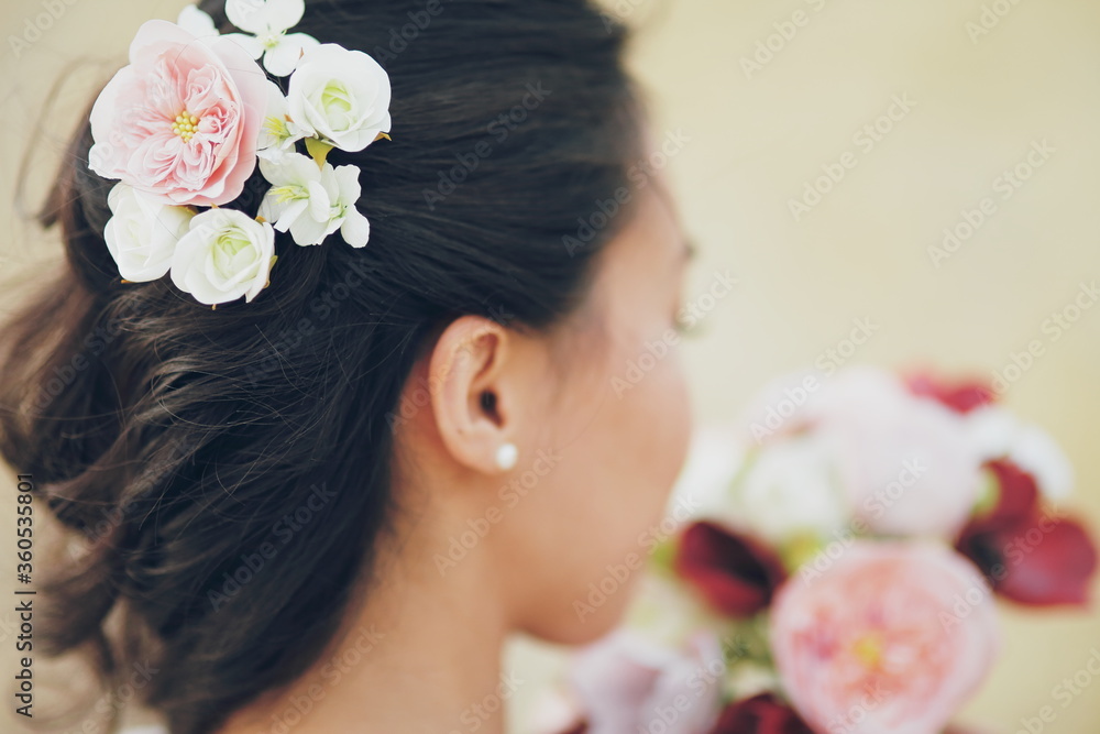 Naklejka premium The girl's hair. Flowers in hair. Wedding bouquet.