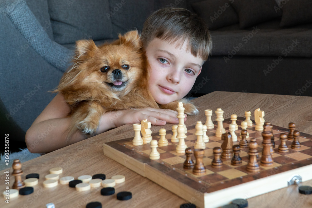 Cheerful child plays chess. A fun game with children in chess