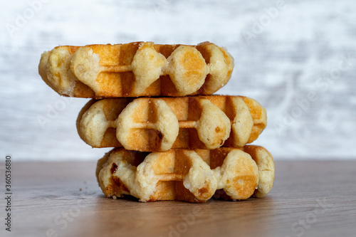 A delicious baked round Belgian waffle with one bite taken.
