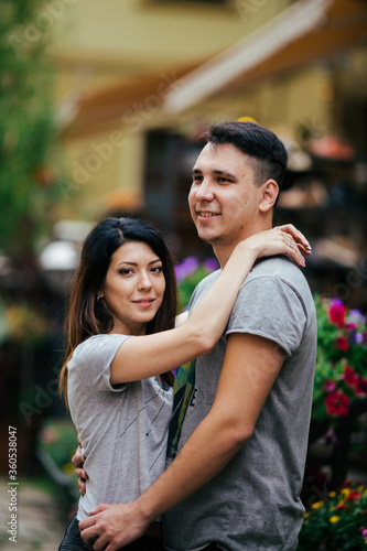 couple posing on the streets of a European city in summer weather.