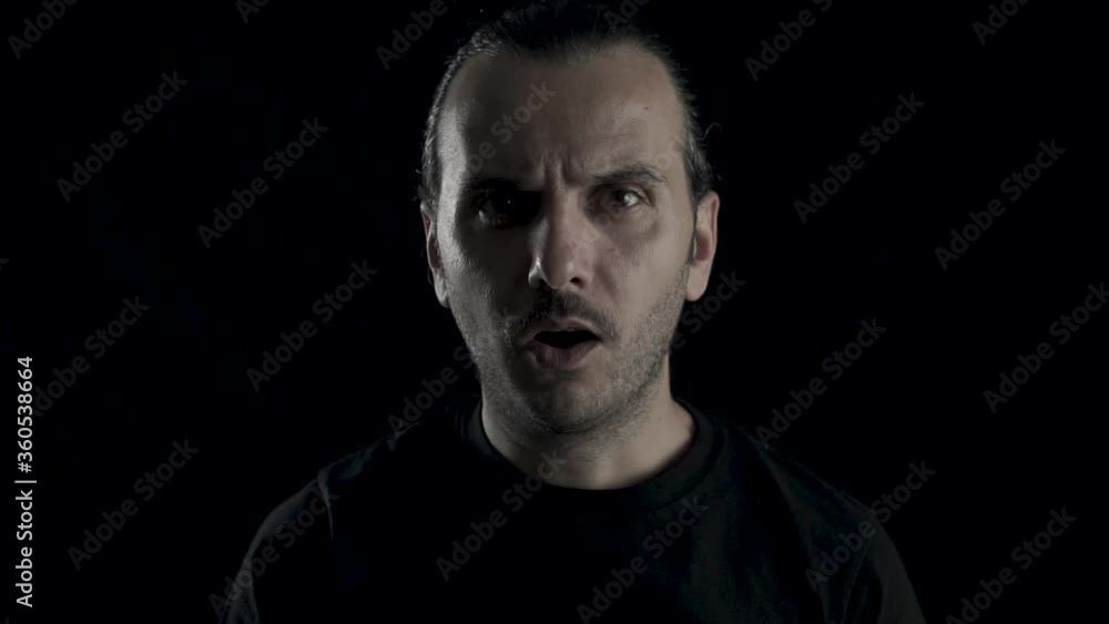 Young handsome guy is unhappy and shocked. Surprised male on black background, studio face shot. Young handsome guy is unhappy and shocked. Surprised male on black background, studio face shot.