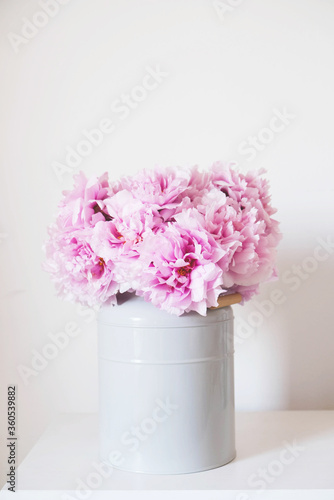 Beautiful bouquet of fresh pink peony flowers in full bloom in vase.