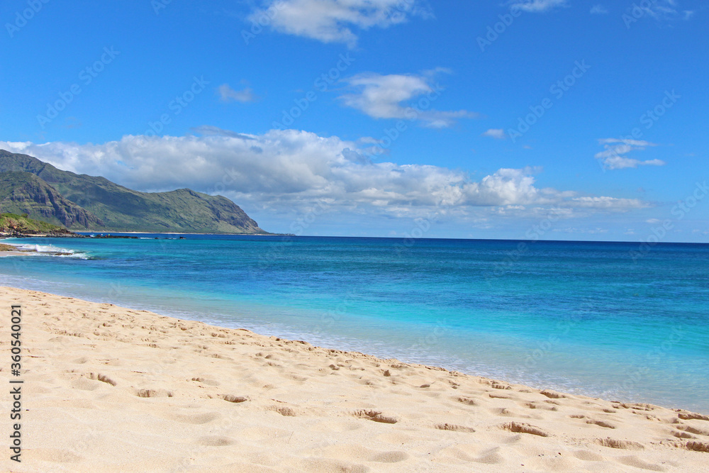 Tropical paradise - Keawaula beach in west side of Oahu, Hawaii. The view on a beautiful white sand beach with turquoise cyan see.
