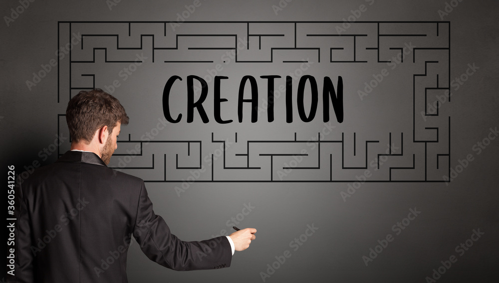 businessman drawing maze with CREATION inscription, business education concept businessman drawing maze with CREATION inscription, business education concept