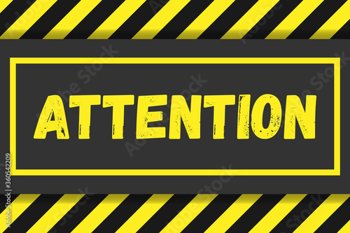 Attention sign on a background of black and yellow stripes. Attention sign design for banner, signboard.