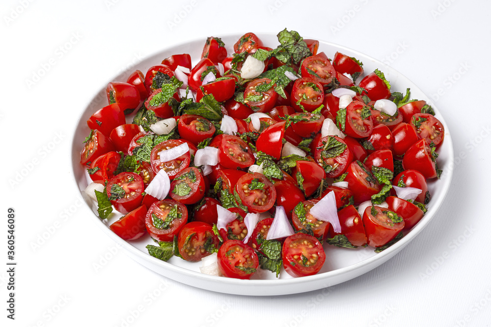 Homemade cherry tomato salad with fresh onions, mint, olive oil and salt Homemade cherry tomato salad with fresh onions, mint, olive oil and salt
