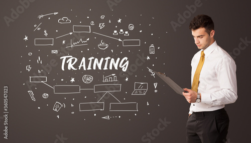 Businessman thinking with TRAINING inscription, business education concept